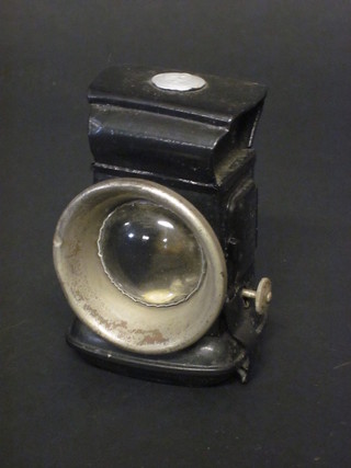A Lucas bicycle lamp contained in a black Japanned case