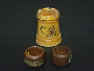 A turned wooden treen money box decorated in the form of a  turret, decorated The Great Wheel Blackpool and 2 teak napkin  rings made from teak from HMS Warspite and a HMS Queen  Elizabeth