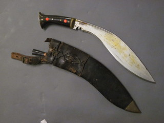A Kukri, the blade marked M43 with leather scabbard, missing 1 skinning knife,  ILLUSTRATED