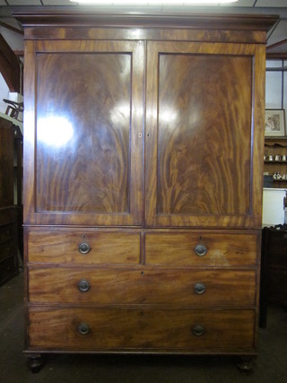 A 19th Century mahogany linen press with moulded cornice, the  interior fitted 3 trays, the base fitted 2 short and 2 long drawers,  raised on bun feet, 58"