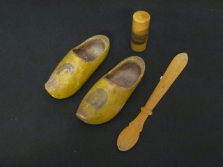 A Victorian treen paper knife decorated scenes of Sidmouth, do.  pair of clogs and a cylindrical jar and cover decorated scenes of  Folkestone