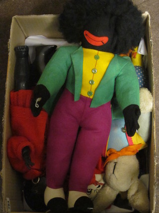 A cardboard box containing a collection of fabric dolls etc
