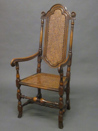 A Carolean style walnut high back chair with woven cane seat  and back, raised on turned and block supports