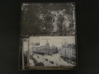 A metal box containing a collection of postcards