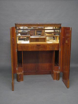 An Art Deco mahogany cocktail cabinet with hinged lid and  fitted interior 40" - THIS LOT IS TO BE OFFERED IN JANUARY COMPLETE WITH ITS INTERFITTING DRINKS TROLLEY AND GLASSWARE 
