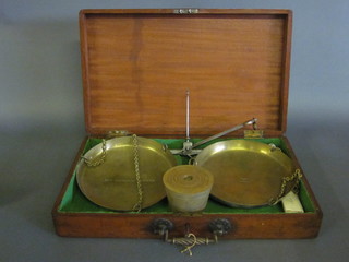 A pair of 19th Century brass and steel scales the brass pans  marked New Shoreham Borough Vincent and Chancellor, complete with a set of 8 interfitting brass troy bucket weights,  contained in a a mahogany case