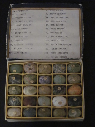A box containing 25 various oval carved geological specimens