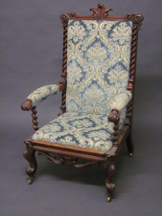 A Victorian carved rosewood open arm chair, raised on cabriole supports, the seat and back upholstered in blue sculptured  material