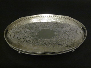 An oval galleried silver plated twin handled tea tray on paw feet  20"