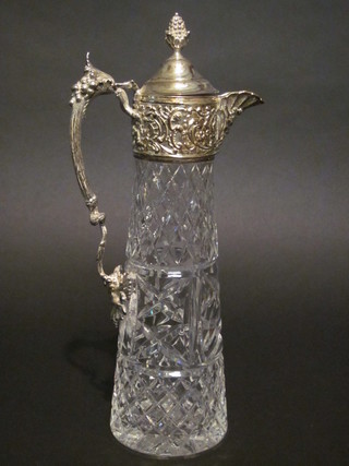 A cut glass claret jug with silver plated mounts