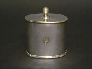 An oval silver plated twin section caddy with armorial decoration  4"