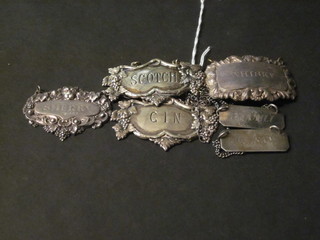 A silver sherry decanter label, 2 Sterling decanter labels marked Pflumli and Whisky and 3 other decanter labels,