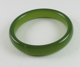 A Chinese green hardstone bangle