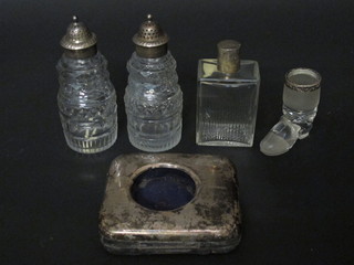 A folding silver travelling watch case Birmingham 1916, 2 Georgian cut glass condiment bottles with silver mounts, a scent  bottle with silver collar and a match striker in the form of a boot
