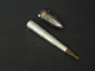 A telescopic silver cigarette holder in a silver bullet shaped case