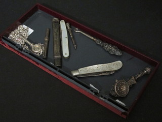 A silver bladed folding fruit knife with mother of pearl grip, a  pocket knife, a silver napkin clip, a silver cased toothpick, a  silver propelling pencil and pencil and an elaborate brooch