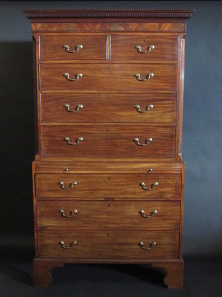 A Georgian mahogany chest on chest, the upper section with moulded and dentil cornice fitted 2 short and 3 long drawers, the  base fitted a brushing slide above 3 long drawers, raised on  bracket feet 44"  ILLUSTRATED