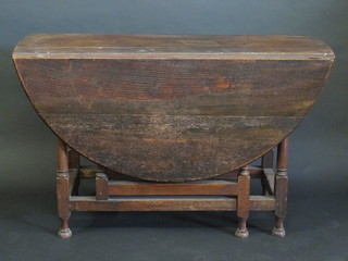A 17th/18th Century oak oval drop flap gateleg dining table,  raised on turned supports 47"