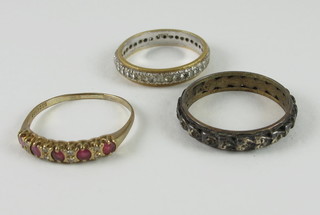 A lady's gold dress ring set red and white stones and 2 eternity  rings