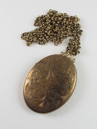 A 9ct gold engraved locket hung on a belcher link chain