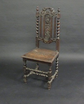A Victorian carved oak Carolean style chair with pierced back  and spiral turned columns to the side with solid seat