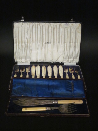 A pair of silver plated fish servers and 6 silver plated fish knives  and forks, cased