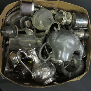 A box containing various silver plated items