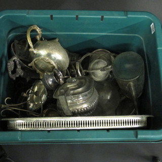 A green plastic crate containing various silver plated items