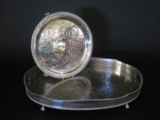 A circular silver plated engraved salver, raised on bracket feet  12" together with an oval silver plated twin handled tea tray 20"