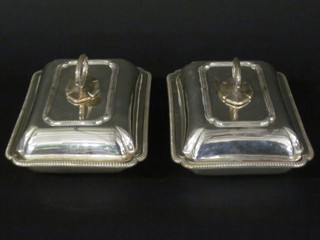 A pair of rectangular silver plated entree dishes and covers