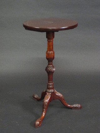 A 19th Century circular mahogany wine table, raised on a carved pillar and tripod base 15"