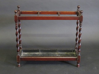 A rectangular mahogany umbrella stand, raised on spiral turned supports complete with drip tray 27"