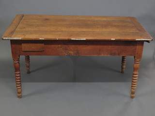 A 19th Century French cherry farmhouse table, fitted a drawer  and with pastry slide, raised on bobbin turned supports 59"