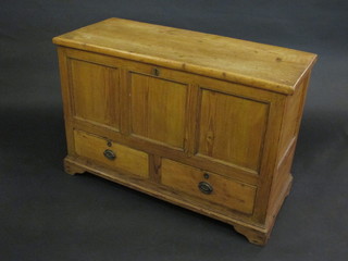 A pine mule chest with hinged lid, the interior fitted a candle  box, the base fitted 2 long drawers, raised on bracket feet 43"