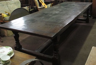 A massive oak refectory dining table, the top formed of 5 planks, raised on turned and block supports with H framed stretcher,  139"