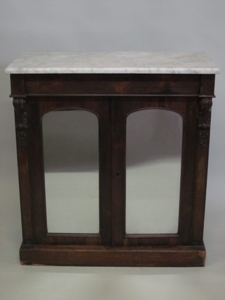 A Victorian rosewood chiffonier with white veined marble top fitted a drawer, the base enclosed by arch shaped mirror panelled  doors, raised on a platform base 33"