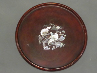 A circular Oriental lacquered tray decorated a bird 12"