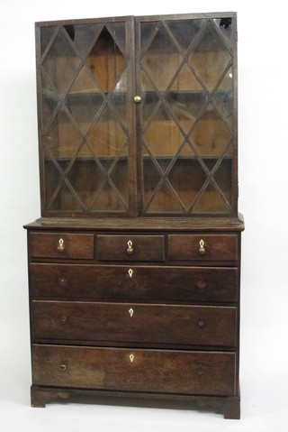 An 18th Century oak bookcase on chest, the upper section fitted adjustable shelves enclosed by astragal glazed panelled doors, the   base fitted 3 short drawers above 3 long drawers with ivory  escutcheons, raised on bracket feet 42"