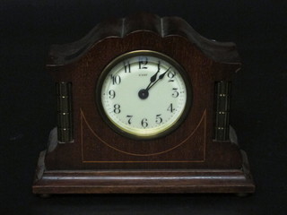 A 1930's 8 day mantel clock with enamelled dial and Arabic numerals contained in an arch shaped mahogany case