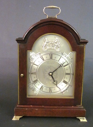 A Garrard 1977 Silver Jubilee limited edition chiming bracket  clock, the silver arched dial decorated the Royal Coat of Arms  and Royal palaces, no 3/250, contained in an arched mahogany  case with silver handle to the top and raised on silver bracket feet
