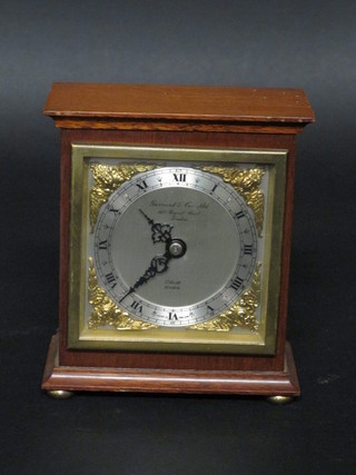 A mantel clock with silvered dial by Elliott, retailed by Garrards  contained in a walnut case