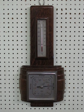 A 1930's aneroid barometer and thermometer with silvered dial  contained in an oak case