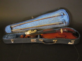 A violin labelled the Artist Apollo, style 12, no. 1930, having a  2 piece back 14", together with 2 bows and contained in a fibre  carrying case
