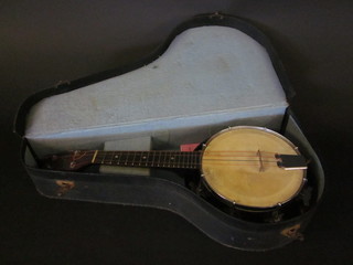 A 4 stringed Ukelele, the head marked Melody-Yuke, contained in a fibre case
