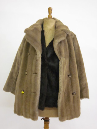 A lady's brown half length fur coat together with a light brown simulated fur coat
