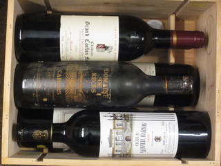 A bottle of 1999 Chateau Leoville Barton St Julien, a bottle of 2000 Chateau Lilian Ladouys St Estephe, 2 bottles of 2001  Chateau Grand Corbin St Emilion, 1 bottle of 1967 Chateau  Puyfromage and 1 bottle 1983 Cahors, contained in a wooden  box