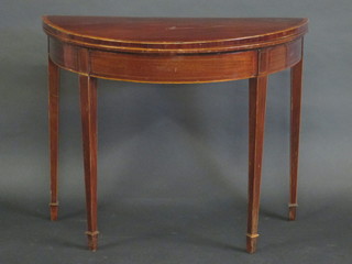 A Georgian mahogany demi-lune card table with crossbanded  top, raised on square tapering supports ending in spade feet, 36"
