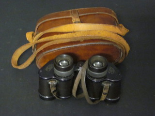 A pair of Zeiss 8 x 24 field glasses contained in a leather case