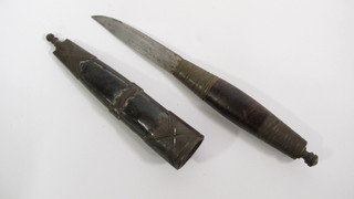 An Eastern dagger with 4" blade contained in a leather and gilt mounted scabbard