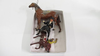 A metal figure of a mounted hunts woman, f, and 1 other Red  Indian